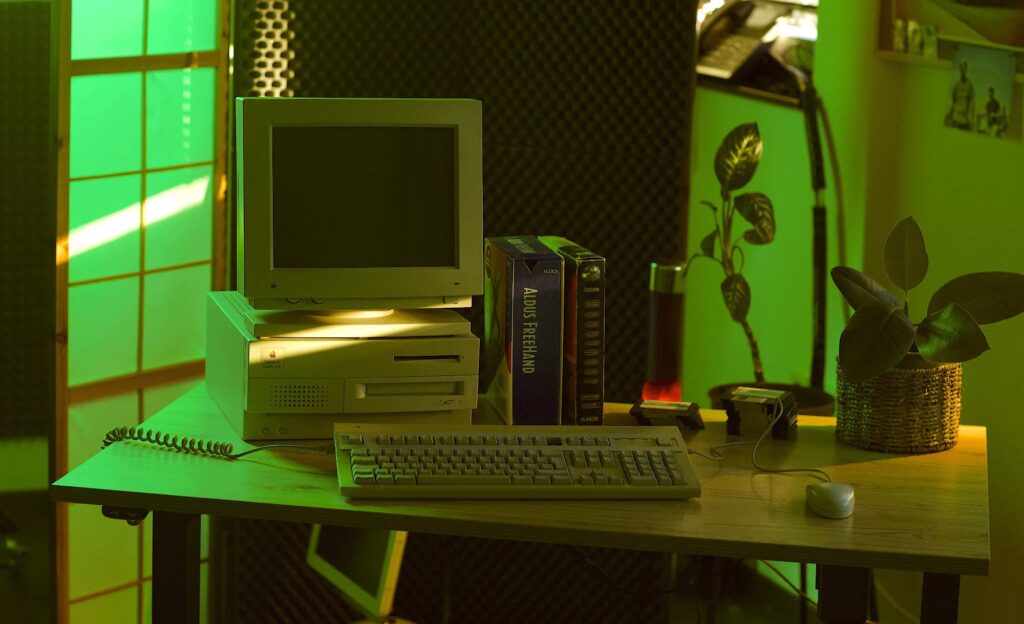 A Mac Centris 650 with keyboard, mouse and software on a desk.